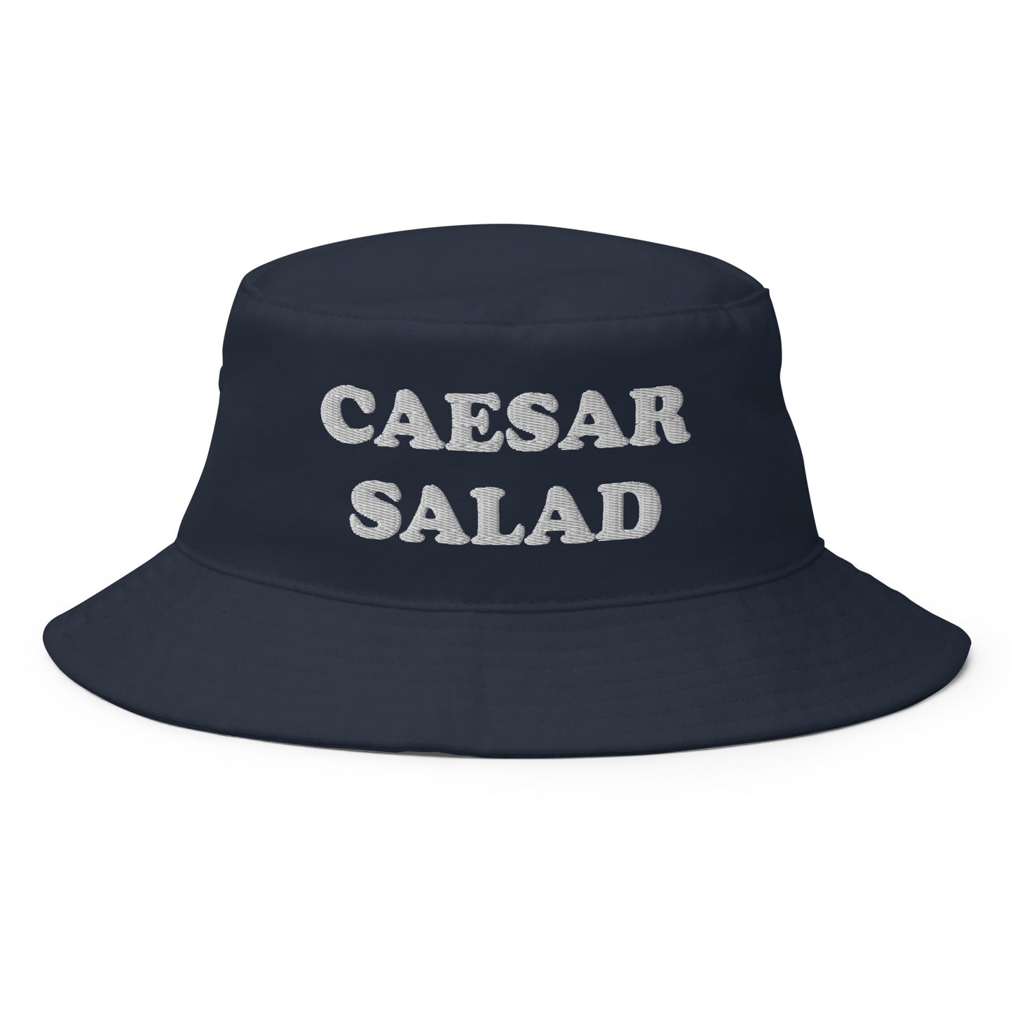 Navy Caesar Salad Bucket Hat - Love Caesar Salad? Looking for a funny foodie hat? This Caesar Salad Bucket Hat is just what you need! It's comfortable and comes in a variety of colors with "Caesar Salad", expertly embroidered across the front. The perfect weird hat for Salad enthusiasts and foodies of all kinds. Celebrate your favorite foods in our funky foodie clothing and accessories.