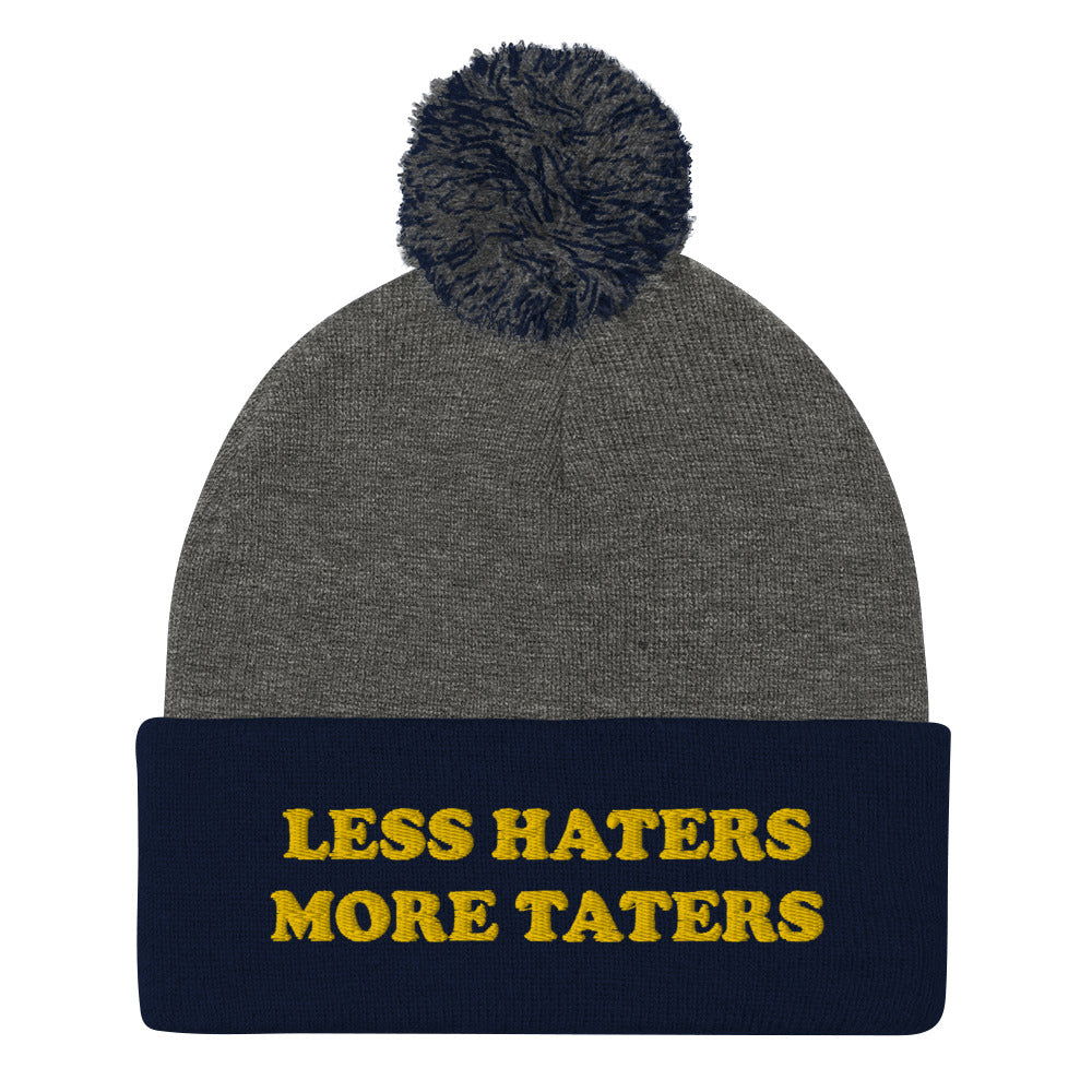 Navy and Gray Less Haters More Taters Hat from Nina's Funky Shop - Lover potatoes? Looking for a funny gift? This warm and cozy, embroidered beanie is just what you need. It's a classic pom pom beanie with "less haters more taters", expertly embroidered on the front. The perfect funny beanie for potato enthusiasts and foodies of all kinds. Celebrate your favorite foods in our funky foodie apparel.