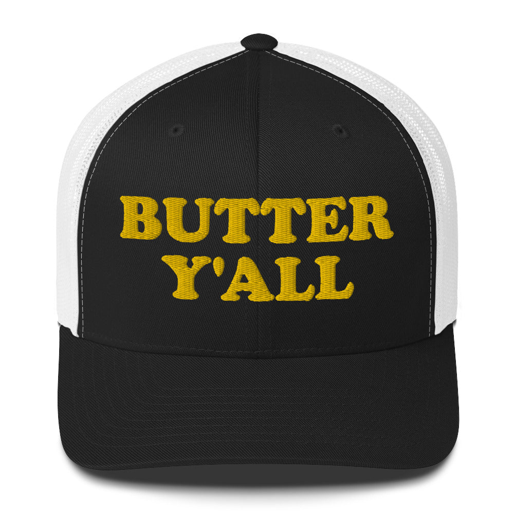 Black and white Butter Hat - Are you a butter enthusiast? Looking for a funny gift? Our Butter Y'all Hat is comfortable and made just for you. It comes in a variety of colors with a funny butter phrase, expertly embroidered on the front. Make a statement and eat your favorite buttery foods in our butter y'all trucker hat. Edit alt text