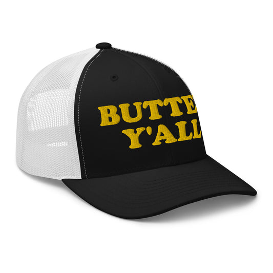 Black and white Butter Hat - Are you a butter enthusiast? Looking for a funny gift? Our Butter Y'all Hat is comfortable and made just for you. It comes in a variety of colors with a funny butter phrase, expertly embroidered on the front. Make a statement and eat your favorite buttery foods in our butter y'all trucker hat. Edit alt text