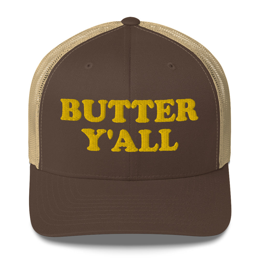 Brown and khaki Butter Hat - Are you a butter enthusiast? Looking for a funny gift? Our Butter Y'all Hat is comfortable and made just for you. It comes in a variety of colors with a funny butter phrase, expertly embroidered on the front. Make a statement and eat your favorite buttery foods in our butter y'all trucker hat. Edit alt text