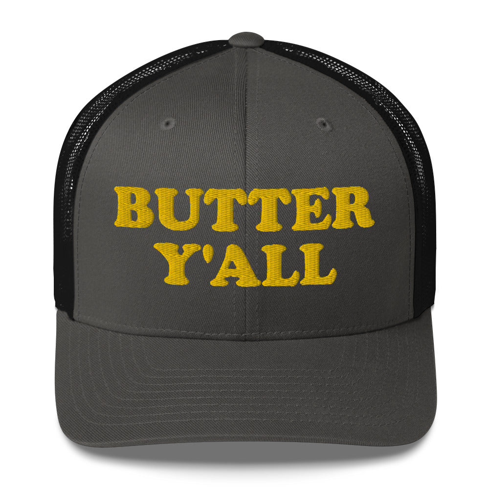 Black and Dark Gray Butter Hat - Are you a butter enthusiast? Looking for a funny gift? Our Butter Y'all Hat is comfortable and made just for you. It comes in a variety of colors with a funny butter phrase, expertly embroidered on the front. Make a statement and eat your favorite buttery foods in our butter y'all trucker hat. Edit alt text
