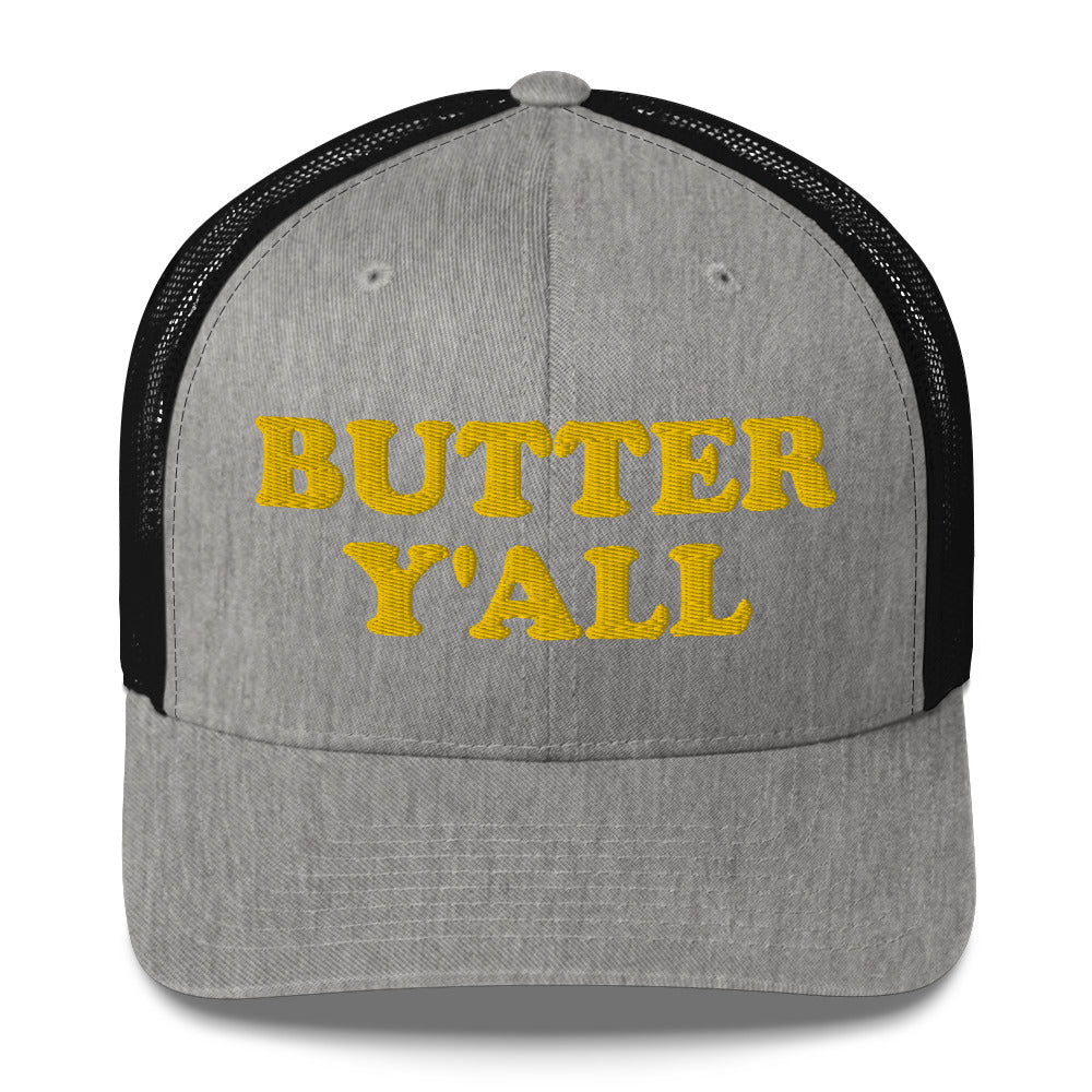 Light Gray and black Butter Hat - Are you a butter enthusiast? Looking for a funny gift? Our Butter Y'all Hat is comfortable and made just for you. It comes in a variety of colors with a funny butter phrase, expertly embroidered on the front. Make a statement and eat your favorite buttery foods in our butter y'all trucker hat. Edit alt text