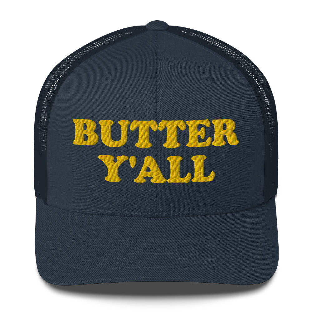 Navy Butter Hat - Are you a butter enthusiast? Looking for a funny gift? Our Butter Y'all Hat is comfortable and made just for you. It comes in a variety of colors with a funny butter phrase, expertly embroidered on the front. Make a statement and eat your favorite buttery foods in our butter y'all trucker hat. Edit alt text