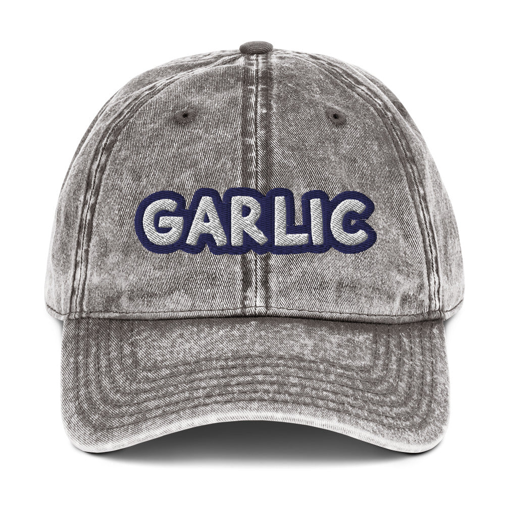 Gray garlic dad hat from Nina's Funky Shop by ninanush - If you're a garlic lover, this funny food hat was designed just for you. Eat garlic in style and make a statement in this stand out foodie dad hat. It's a garlic lover hat that's made of cotton, with a washed out vintage style and an eye-catching blue and white embroidery. Perfect for garlic enthusiasts and foodies of all kinds.