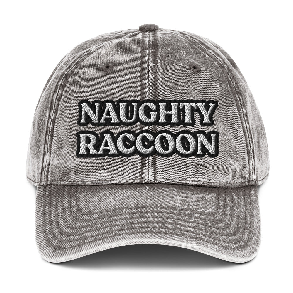 Gray naughty raccoon dad hat from Nina's Funky Shop by ninanush - Stand out in this naughty raccoon hat. It's a vintage style embroidered dad hat with the words "naughty raccoon" in black and white on the front. This unique hat for raccoon enthusiasts is funny and just a little weird. Add a little personality to your everyday style or give it as a funny gift for a raccoon lover.