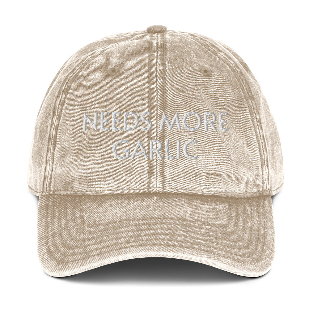 Tan needs more garlic dad hat from Nina's Funky Shop by ninanush - If you're a garlic enthusiast, this funny food hat was designed just for you. Eat garlicky snacks in style and show off your love for garlic in our unique foodie dad hat. This garlic lover hat is made of cotton, with a washed out vintage style and an eye-catching embroidery. Perfect for garlic lovers and foodies.