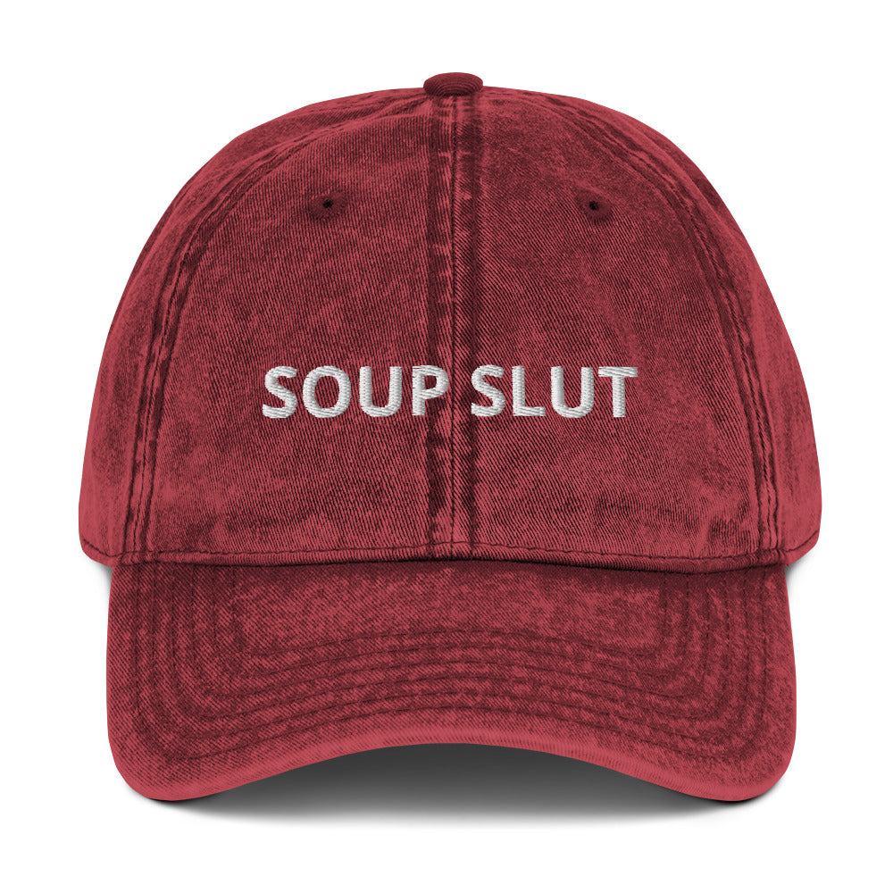 Maroon soup slut hat - Are you a soup slut? Looking for a funny gift for a soup enthusiast? Our Soup Slut Hat is just what you need. It's comfortable, has an adjustable closure, and comes in a variety of colors with "Soup Slut", expertly embroidered on the front. Eat your favorite soups and add a little personality to your everyday style. Celebrate your favorite foods in our funky foodie clothing and accessories.