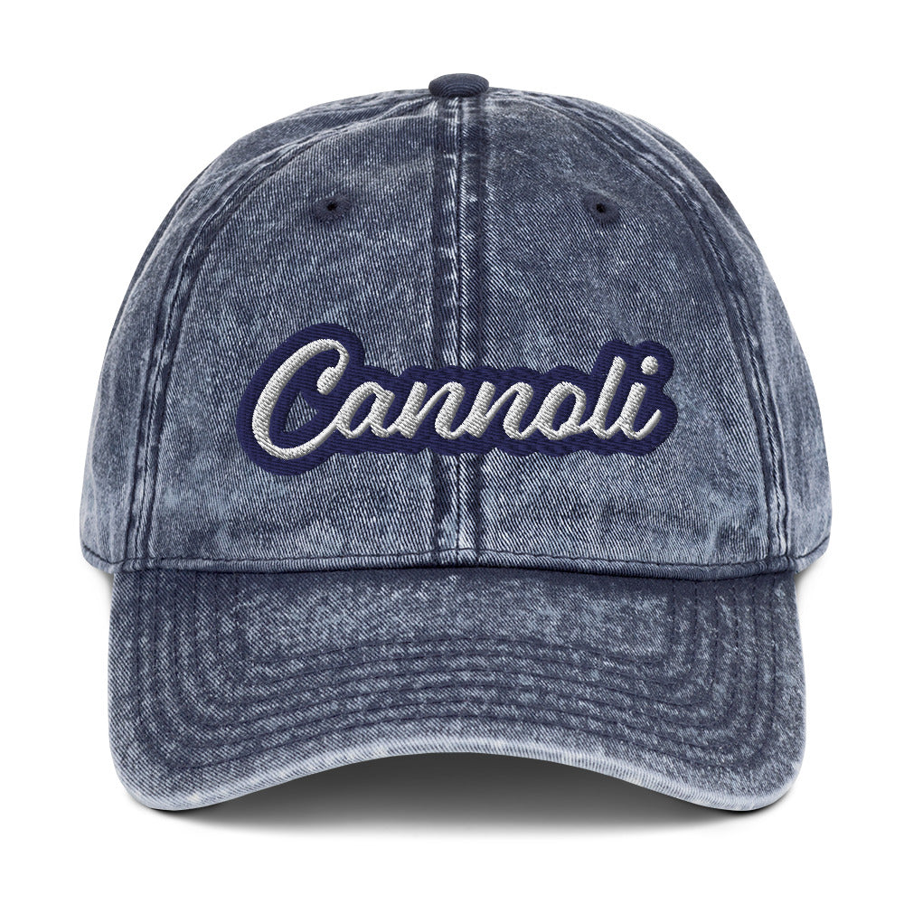 Blue cannoli dad hat - A unique dad can designed for cannoli lovers and foodies. Eat your favorite cannoli in style and show off your love for this classic Italian dessert in our unique foodie dad hat. This cannoli hat is has a washed out vintage style and a white and blue embroidery. Perfect for cannoli lovers and foodies of all kinds.