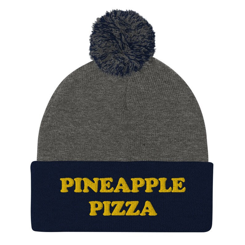 Navy blue and gray pineapple pizza beanie -Are you in the pineapple pizza club? Eat pineapple pizza in style in a funny foodie beanie for pizza lovers. It's a unisex embroidered beanie for pineapple pizza enthusiasts. If you love pineapple pizza, this weird foodie hat is a must have or give this warm and cozy hat as a funny gift for pineapple pizza people.
