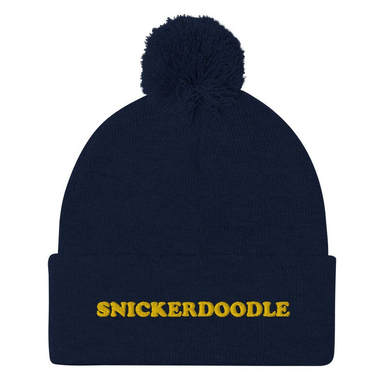 Navy blue snickerdoodle hat - Eat snickerdoodles in style and make a statement in this snickerdoodle beanie. It's a warm and cozy hat for foodies and made just for you. The funny foodie snickerdoodle hat is a classic beanie with a pom pom and a unique embroidery. It's a weird beanie for cookie lovers and a funny gift for snickerdoodle enthusiasts.