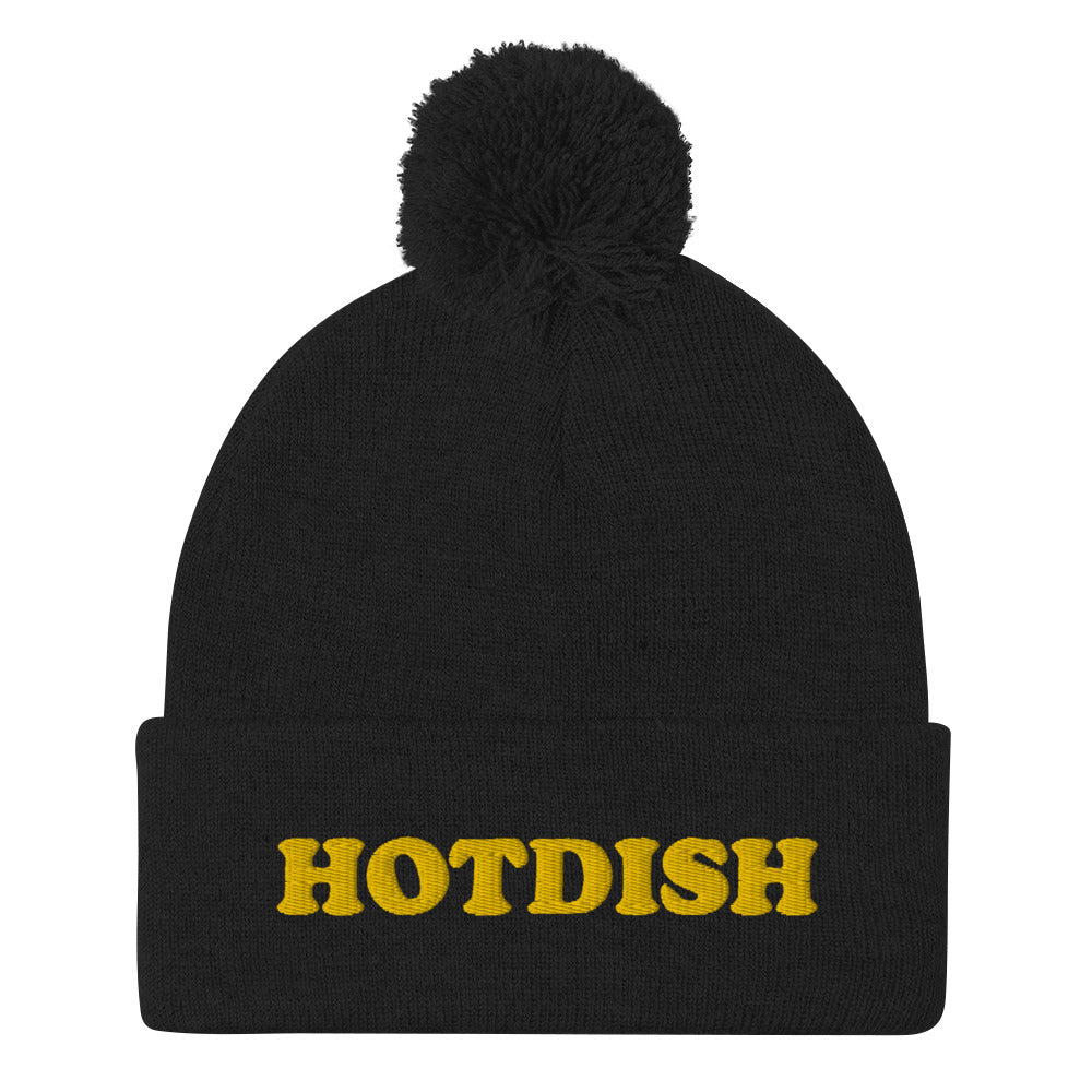 'HOTDISH' Pom-Pom Beanie. This funky foodie beanie is a warm and cozy hat for cold weather. It's a classic beanie with a pom pom and a unique hotdish embroidery. This funny beanie is unique and weird and a perfect funny hat for a unique gift idea. Ideal for foodies who love hotdish and funky foodie beanies.