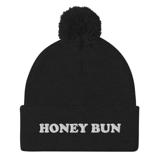 Black honey bun beanie for foodies - Honey Bun Pom-Pom Beanie. This cute foodie beanie is a perfect warm and cozy hat for cold weather. It's a classic beanie with a pom pom on top and unique white embroidery. The funny honey bun hat is a weird foodie hat that's a perfect gift for foodies and honey bun lovers. Stay warm in our funky foodie clothing.