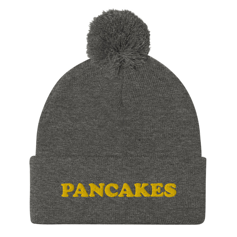 Everyone loves pancakes and now you can show your love in this funny foodie pancake beanie. This unique embroidered "PANCAKES" beanie is warm and cozy with a classic pom pom. It's a perfect gift for foodies and weird hat people. Shop vegan foodie beanies, garlic hoodies, and funky designs in our shop.