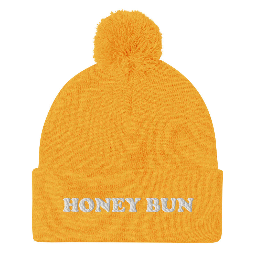 Yellow honey bun beanie hat - Honey Bun Pom-Pom Beanie. This cute foodie beanie is a perfect warm and cozy hat for cold weather. It's a classic beanie with a pom pom on top and unique white embroidery. The funny honey bun hat is a weird foodie hat that's a perfect gift for foodies and honey bun lovers. Stay warm in our funky foodie clothing.
