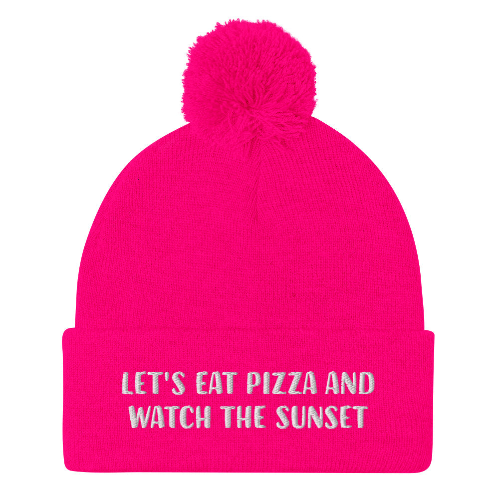 Hot pink funny foodie beanie. Chase the sunset and eat pizza beanie - Let's eat pizza and watch the sunset in a unique beanie with a funny message. This cute beanie is a warm hat for cozy nights in and outdoor adventures. It's a classic unisex embroidered beanie with a pom pom on top. Love sunsets and pizza? Wear this funny foodie beanie or give it as a unique gift for pizza lovers.