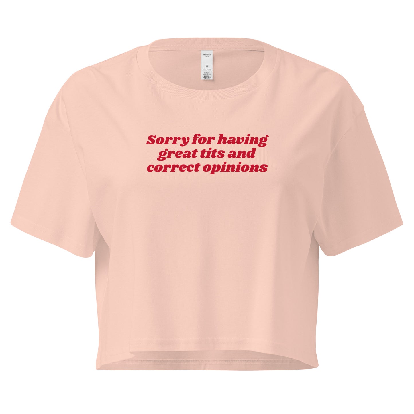 Pale Pink crop t-shirt with the text 'Sorry for having great tits and correct opinions' printed in red on the front.