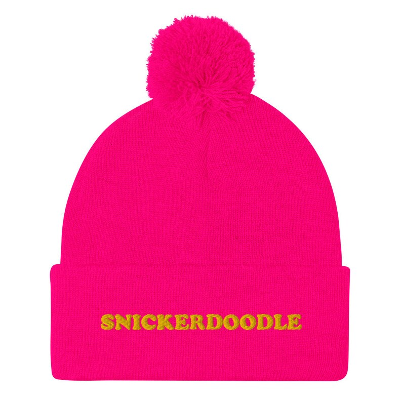 Hot pink snickerdoodle cookie hat - Eat snickerdoodles in style and make a statement in this snickerdoodle beanie. It's a warm and cozy hat for foodies and made just for you. The funny foodie snickerdoodle hat is a classic beanie with a pom pom and a unique embroidery. It's a weird beanie for cookie lovers and a funny gift for snickerdoodle enthusiasts.