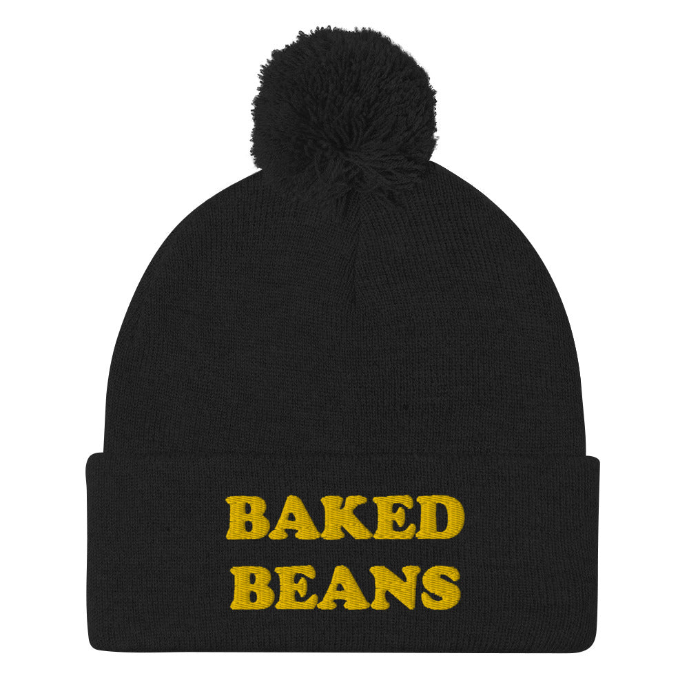 'BAKED BEANS' Pom-Pom Beanie. This funky foodie beanie is a warm and cozy hat for cold weather. It's a weird food beanie with a unique baked beans embroidery. This funny beanie is a perfect funny hat for a weird and funny gift idea. Ideal for foodies who love baked beans and funky fashion. Shop baked beans hats and more.