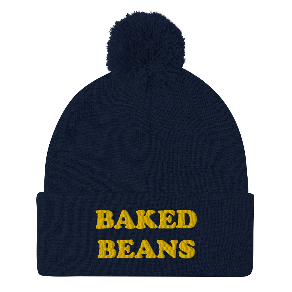 'BAKED BEANS' Pom-Pom Beanie. This funky foodie beanie is a warm and cozy hat for cold weather. It's a weird food beanie with a unique baked beans embroidery. This funny beanie is a perfect funny hat for a weird and funny gift idea. Ideal for foodies who love baked beans and funky fashion. Shop baked beans hats and more.